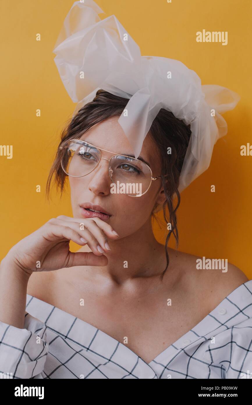 Portrait of a beautiful woman wearing spectacles and a plastic turban Stock Photo