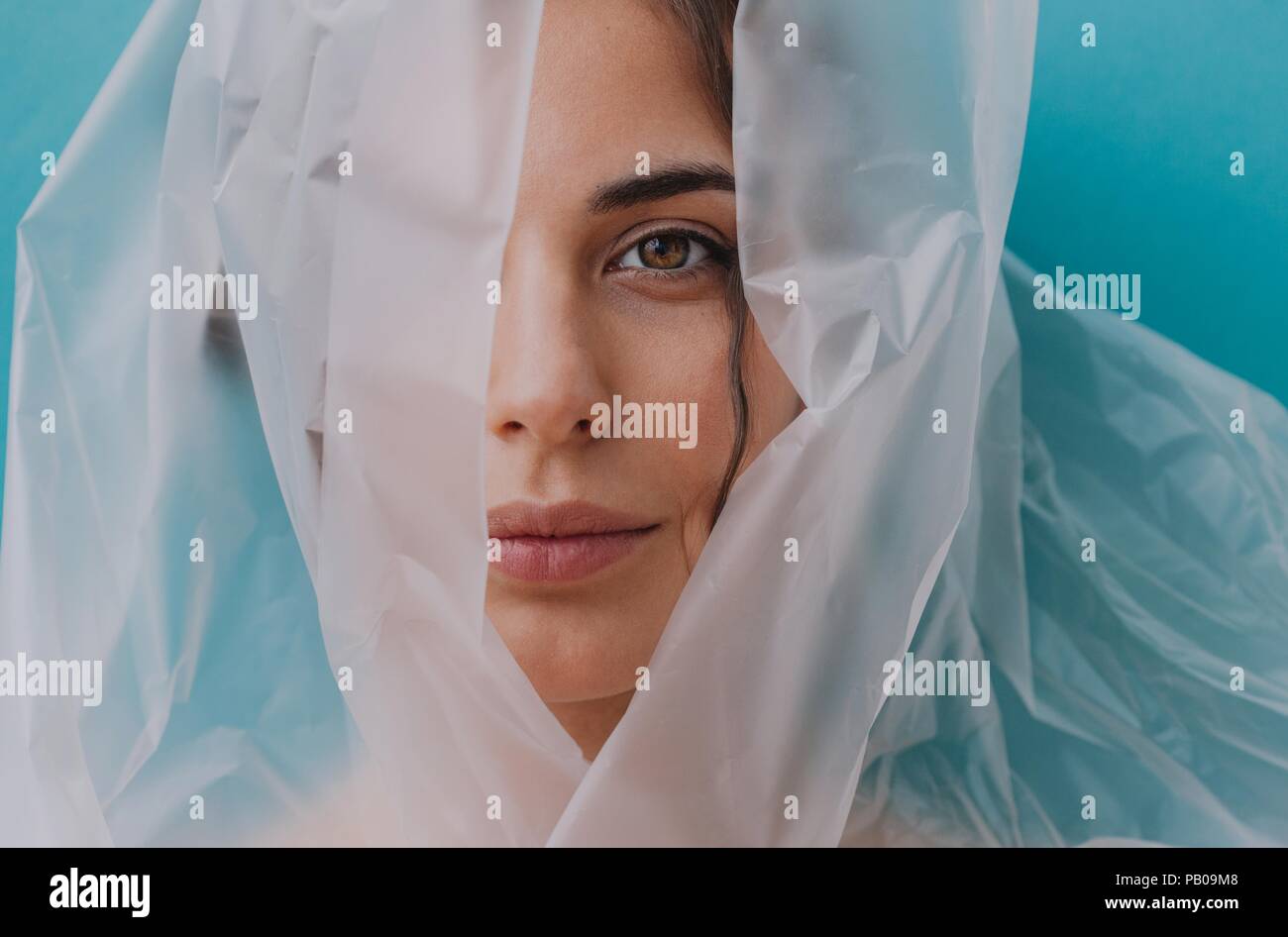 Portrait of a woman wrapped in transparent plastic Stock Photo