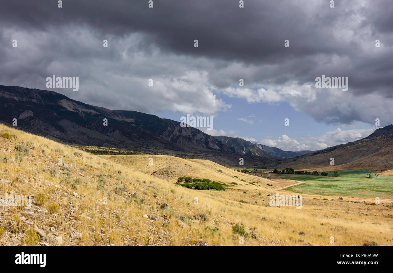 Cody, Wyoming, USA - View across the rugged undulating landscape of Buffalo Bill State park showing the rocky mountains near Cody, Wyoming, USA. Stock Photo