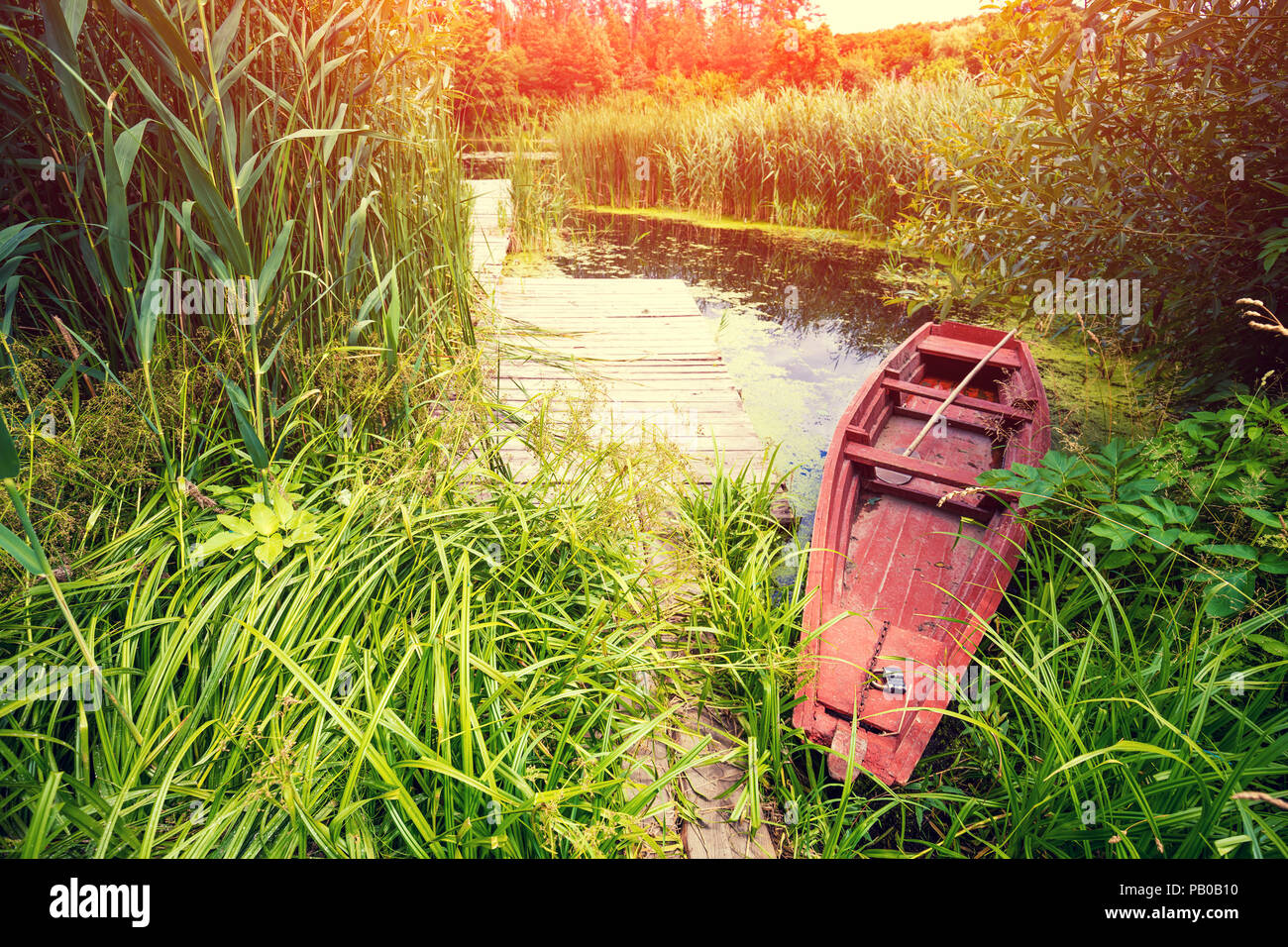 Wooden boat on the river bank Stock Photo - Alamy