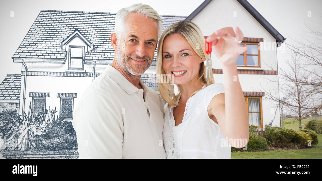 Composite image of happy couple showing their new house key Stock Photo ...