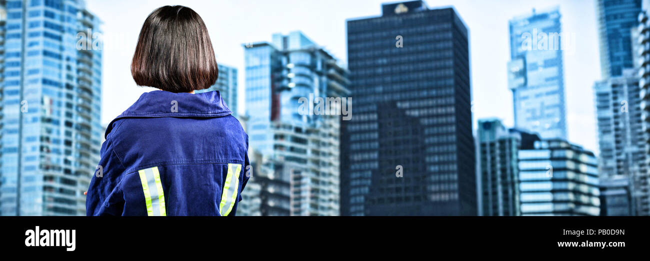 Composite image of female architect standing against white background Stock Photo