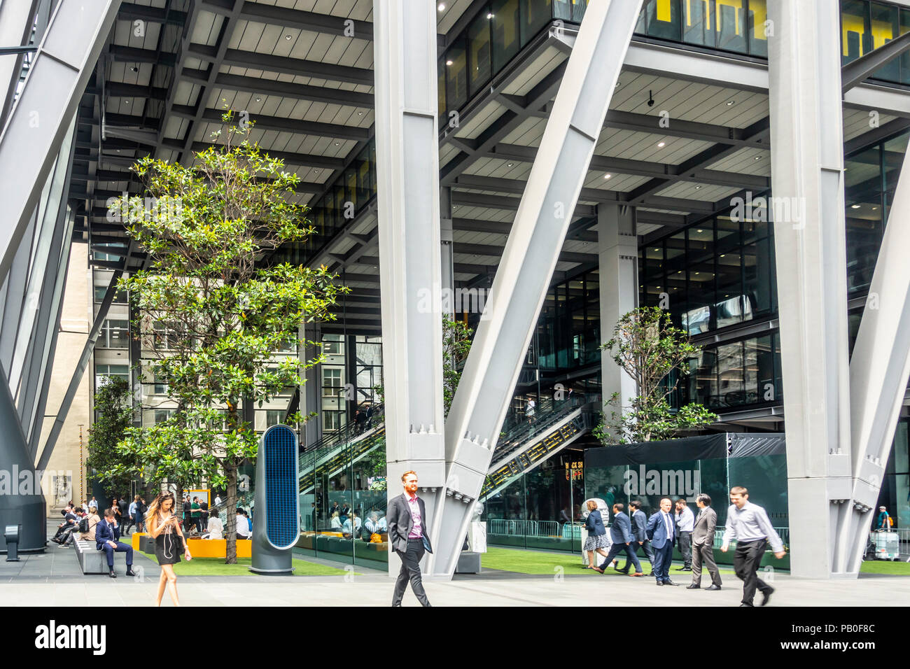 Men and women using and walking past the public space atrium at the foot of the Leadenhall Building in central London, England, UK Stock Photo