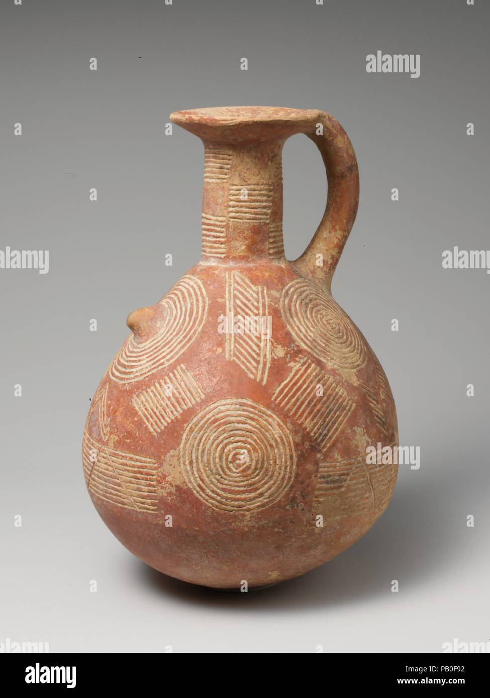 Terracotta jug. Culture: Cypriot. Dimensions: H. 7 5/16 in. (18.6 cm). Date: ca. 2500-1900 B.C..  Globular with handle, concentric circles and groups of lines. Museum: Metropolitan Museum of Art, New York, USA. Stock Photo