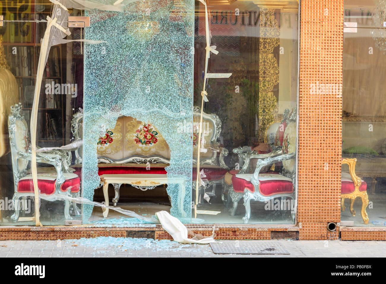 Broken window of a furniture shop in Sharjah, UAE Stock Photo Alamy