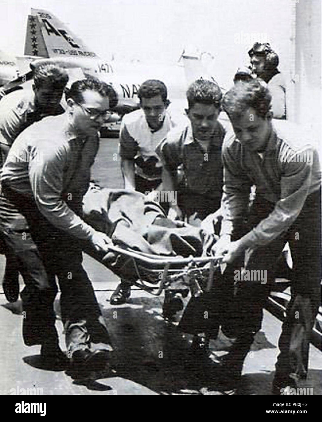 A wounded crewmen of USS Liberty (AGTR-5) is carried on the flight deck of USS America (CVA-66) 9 June 1967. Stock Photo