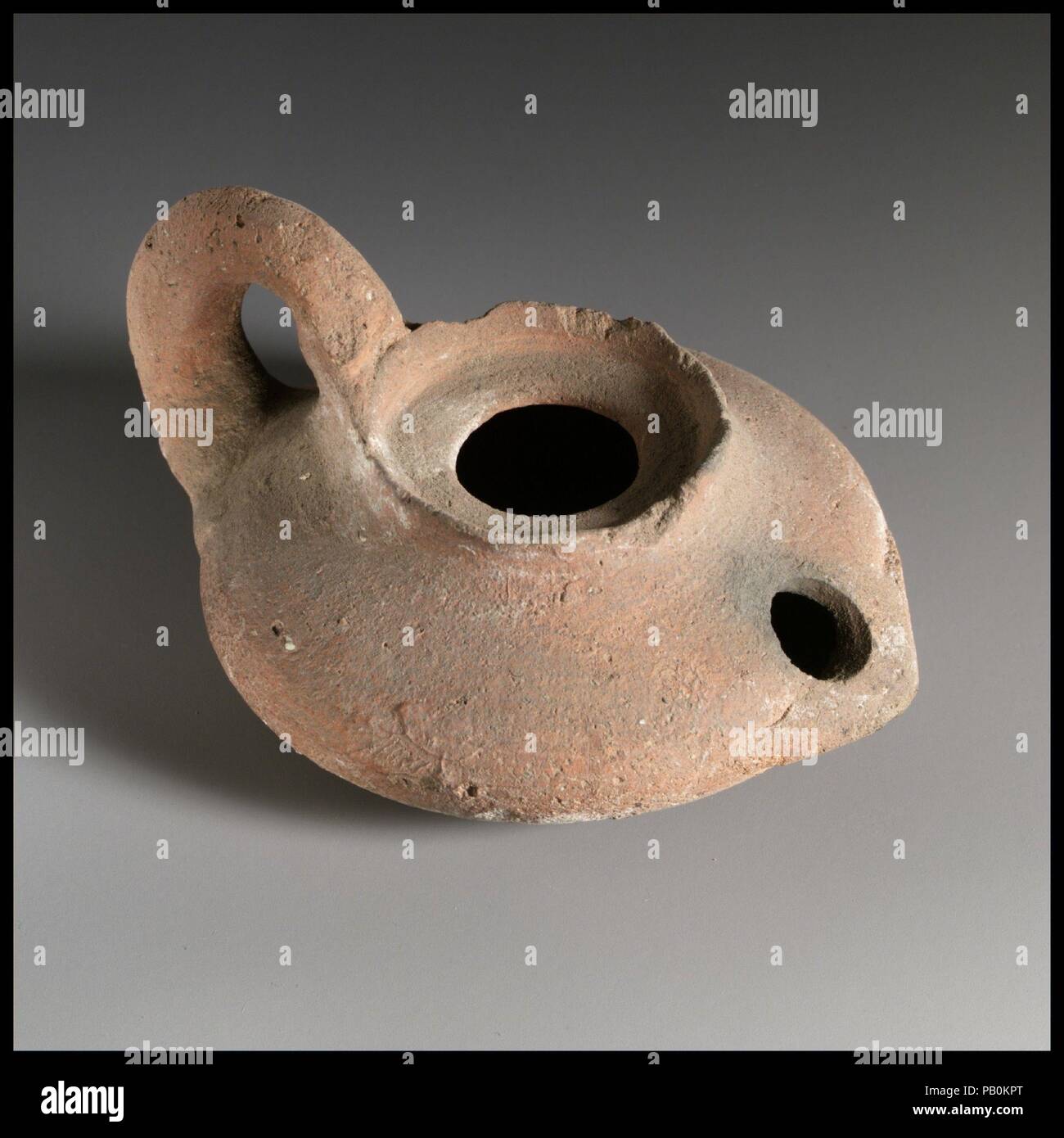 Terracotta lamp. Dimensions: Overall: 2 x 3 3/4 in. (5.1 x 9.5 cm). Date: 3rd century B.C.. Museum: Metropolitan Museum of Art, New York, USA. Stock Photo