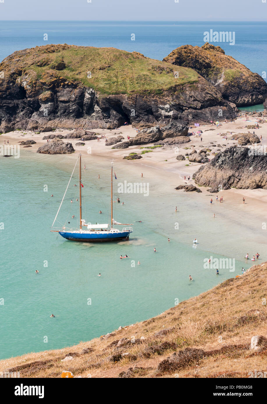 Summer in Cornwall holiday makers at Kynance Cove on the Lizard
