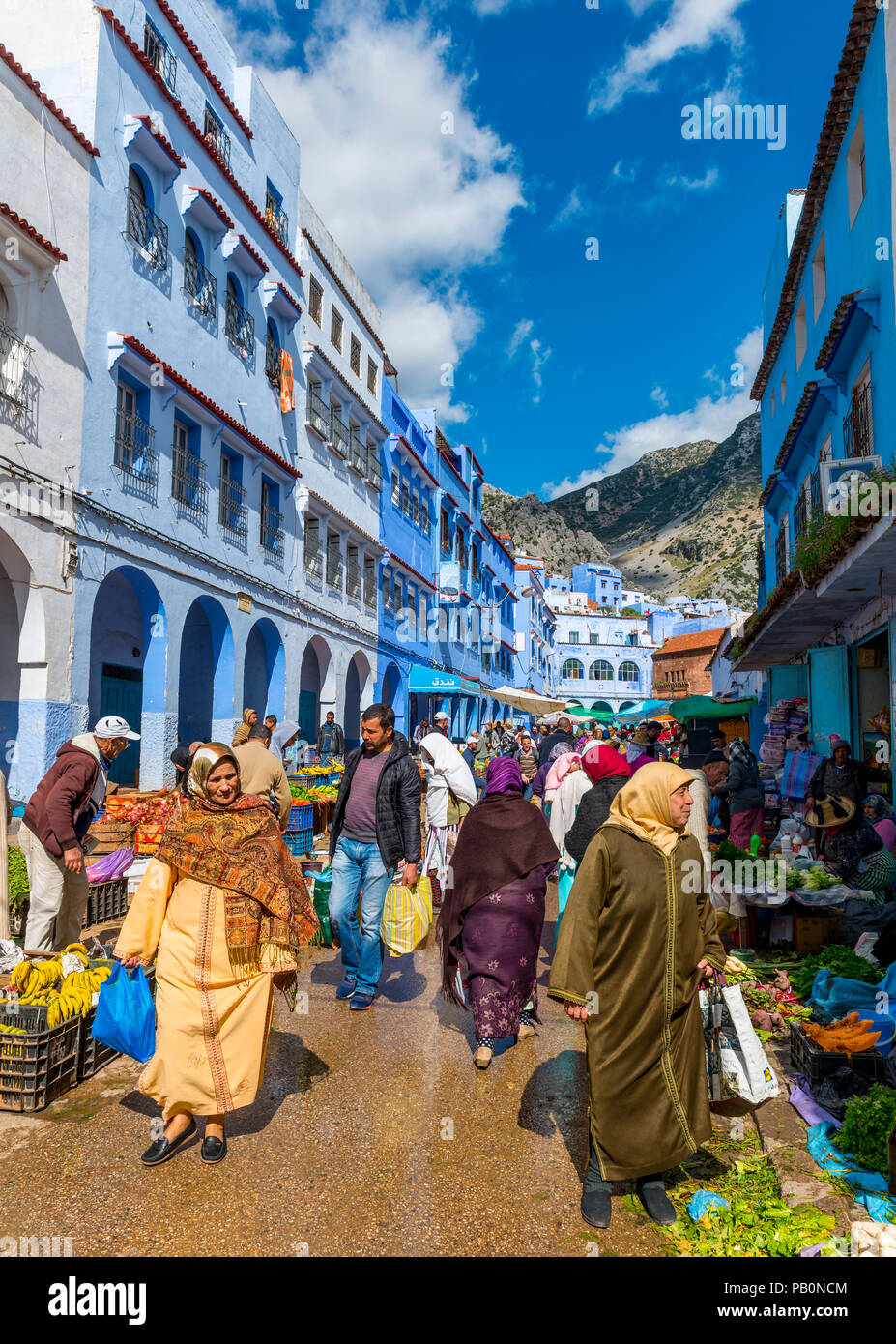 Locals buying vegetables and fruits, market in front of Blue Houses