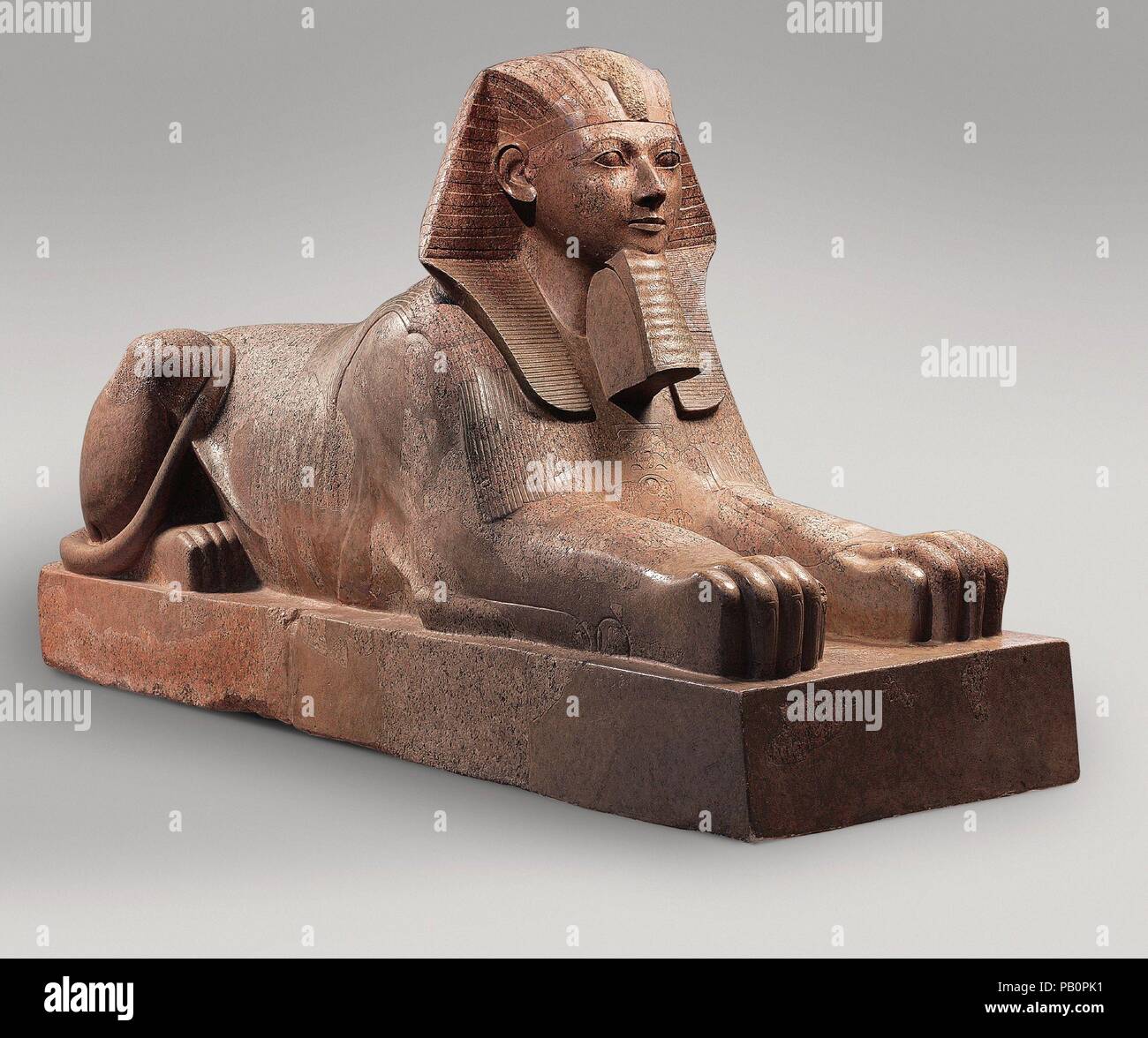 Sphinx of Hatshepsut. Dimensions: H: 164 cm (64 9/16 in.); L: 343 cm (135 1/16 in.); Wt: 6758.6 kg (14900  lb.). Dynasty: Dynasty 18. Reign: Joint reign of Hatshepsut and Thutmose III. Date: ca. 1479-1458 B.C..  This colossal sphinx portrays the female pharaoh Hatshepsut with the body of a lion and a human head wearing a nemes headcloth and royal beard.  The sculptor has carefully observed the powerful muscles of the lion as contrasted to the handsome, idealized face of the pharaoh. It was one of at least six granite sphinxes that stood in Hatshepsut's mortuary temple at Deir el-Bahri.  Smashe Stock Photo
