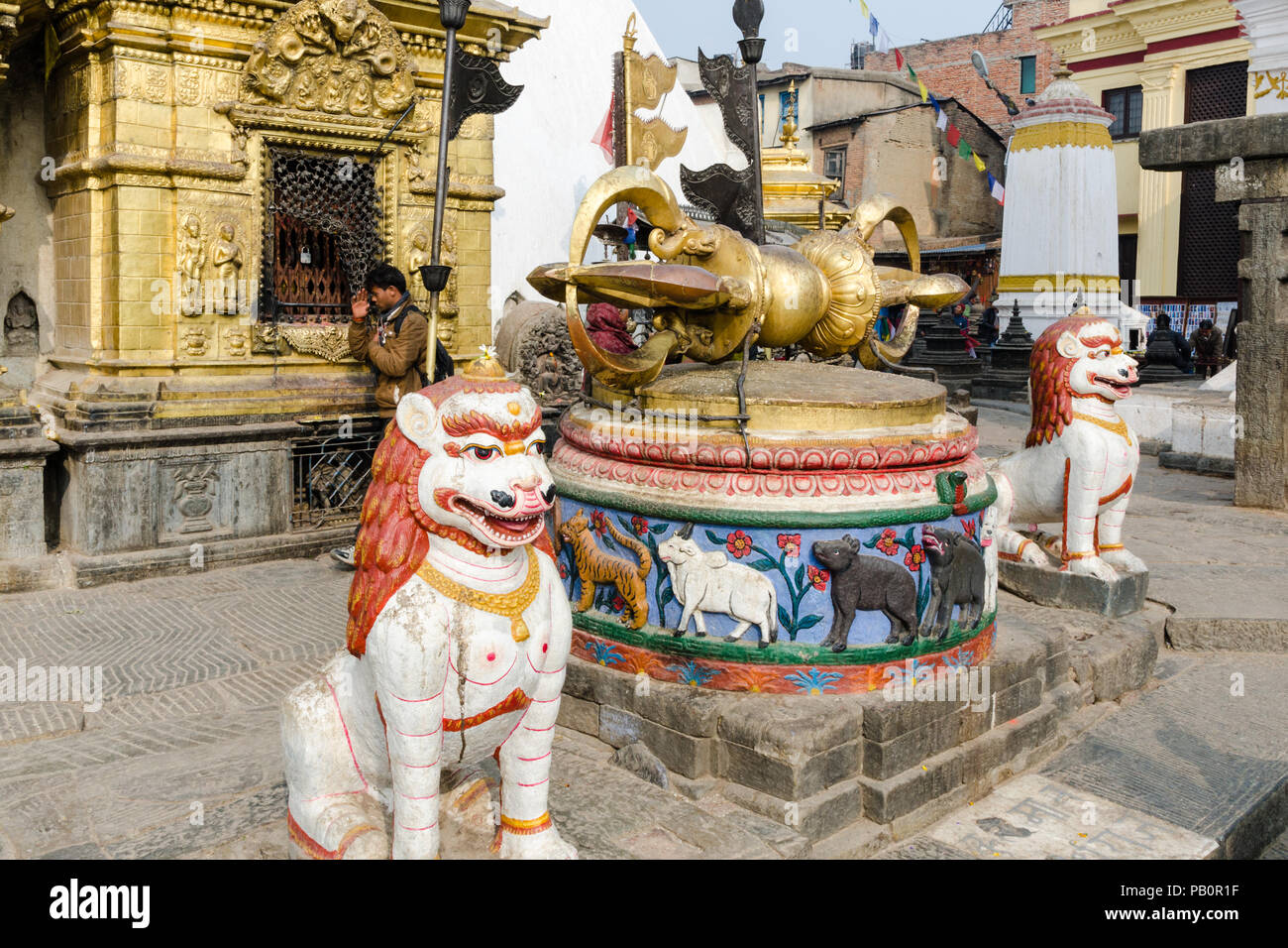 The golden Vajra and the two lions guarding the entrance of Swayambhunath or Monkey Temple, Kathmandu, Nepal Stock Photo