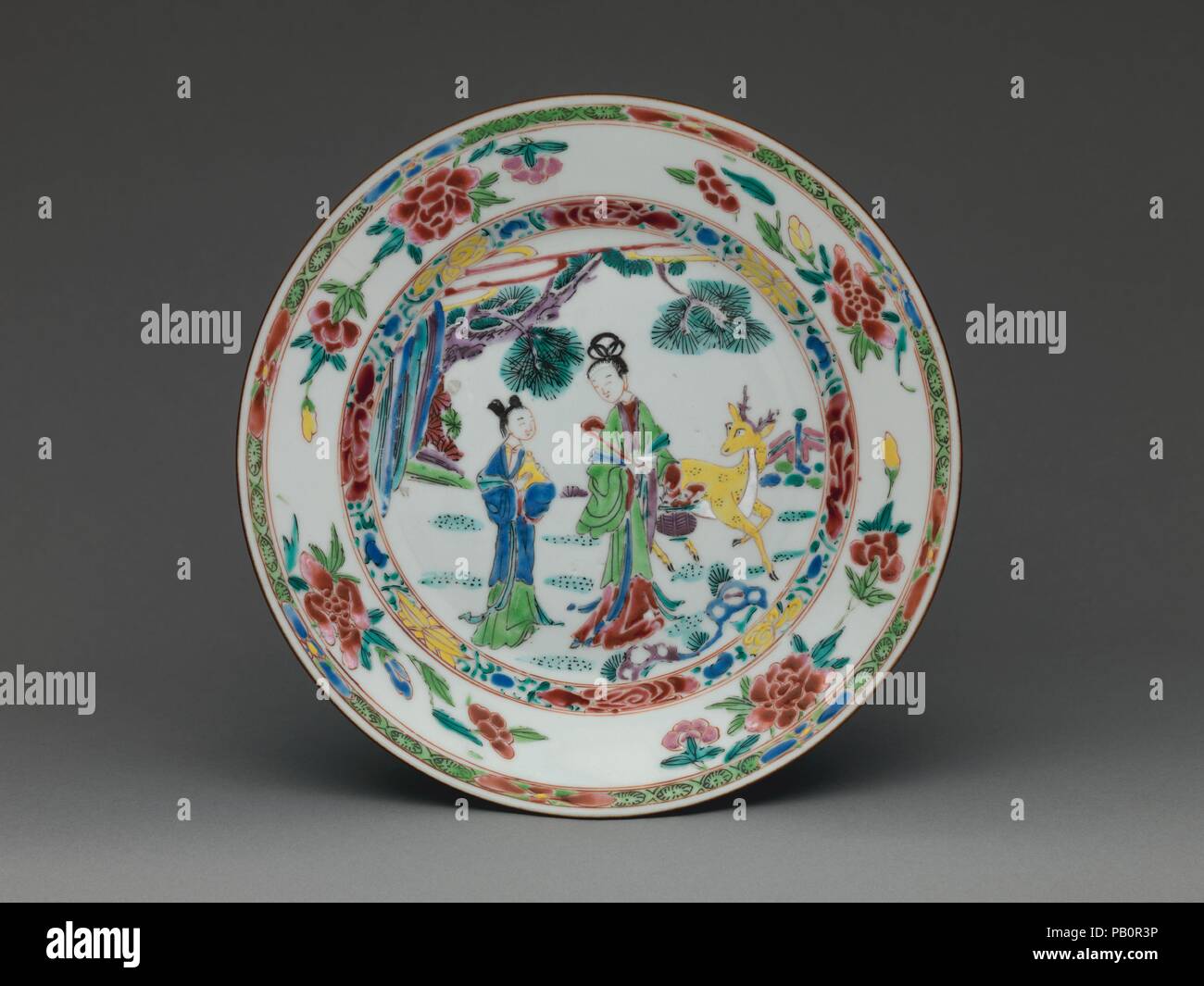 Plate. Culture: Chinese, for British market. Dimensions: Overall (confirmed): 1 × 9 × 9 in. (2.5 × 22.9 × 22.9 cm). Date: ca. 1723-35.  A Chinese plate painted with this exact composition must have served as a model for the painters at the Bow factory in England, for a Bow plate in the Museum's collection (2014.600) is decorated with precisely the same composition executed in a very similar palette. Surprisingly, one is able to match a piece of British or European porcelain with a Chinese prototype relatively rarely, and it is even more unusual to find an original model that has been copied wi Stock Photo