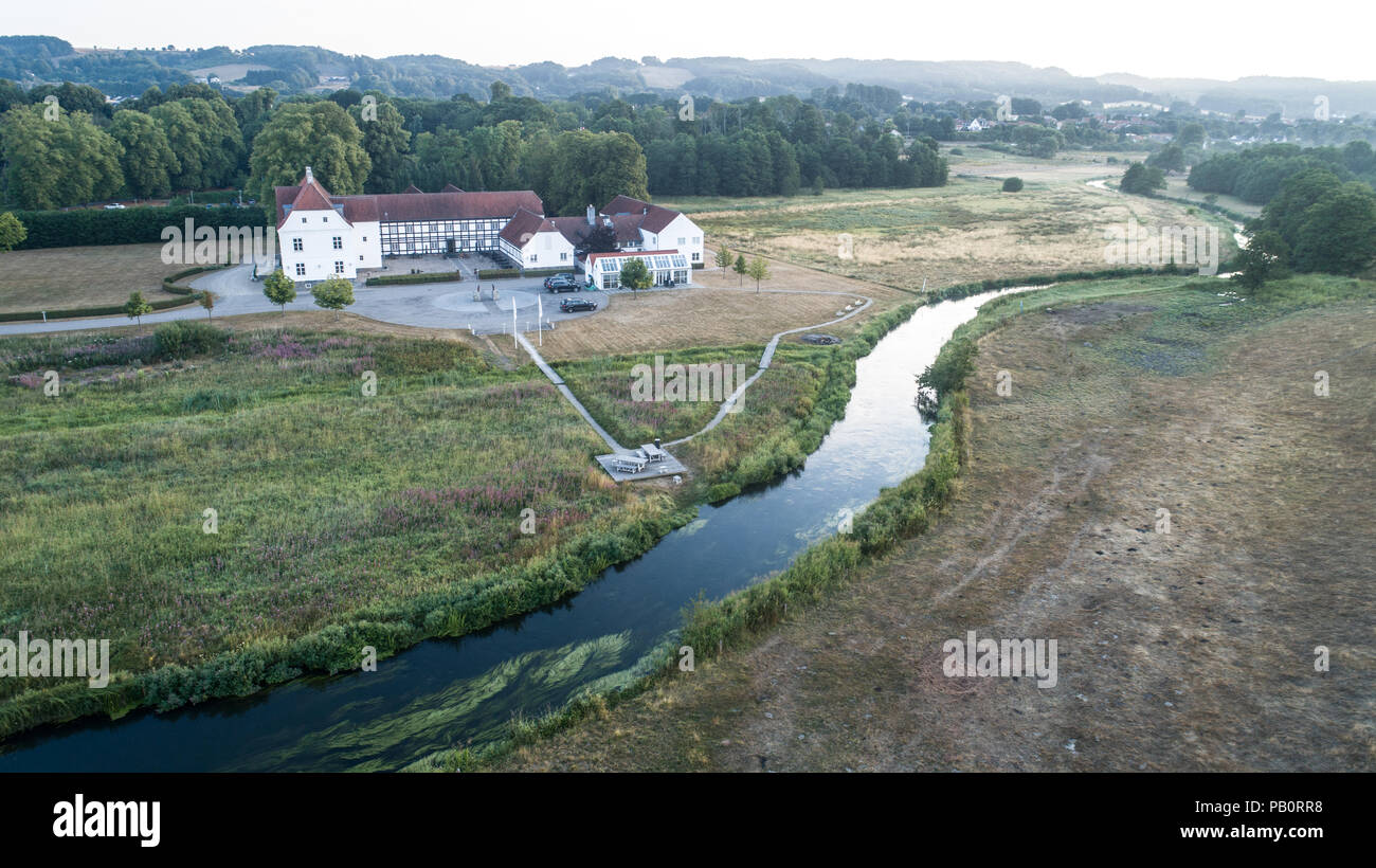 Aerial image of the beautiful valley at Vejle Å and the historic Haraldskær Manor in Denmark. Stock Photo