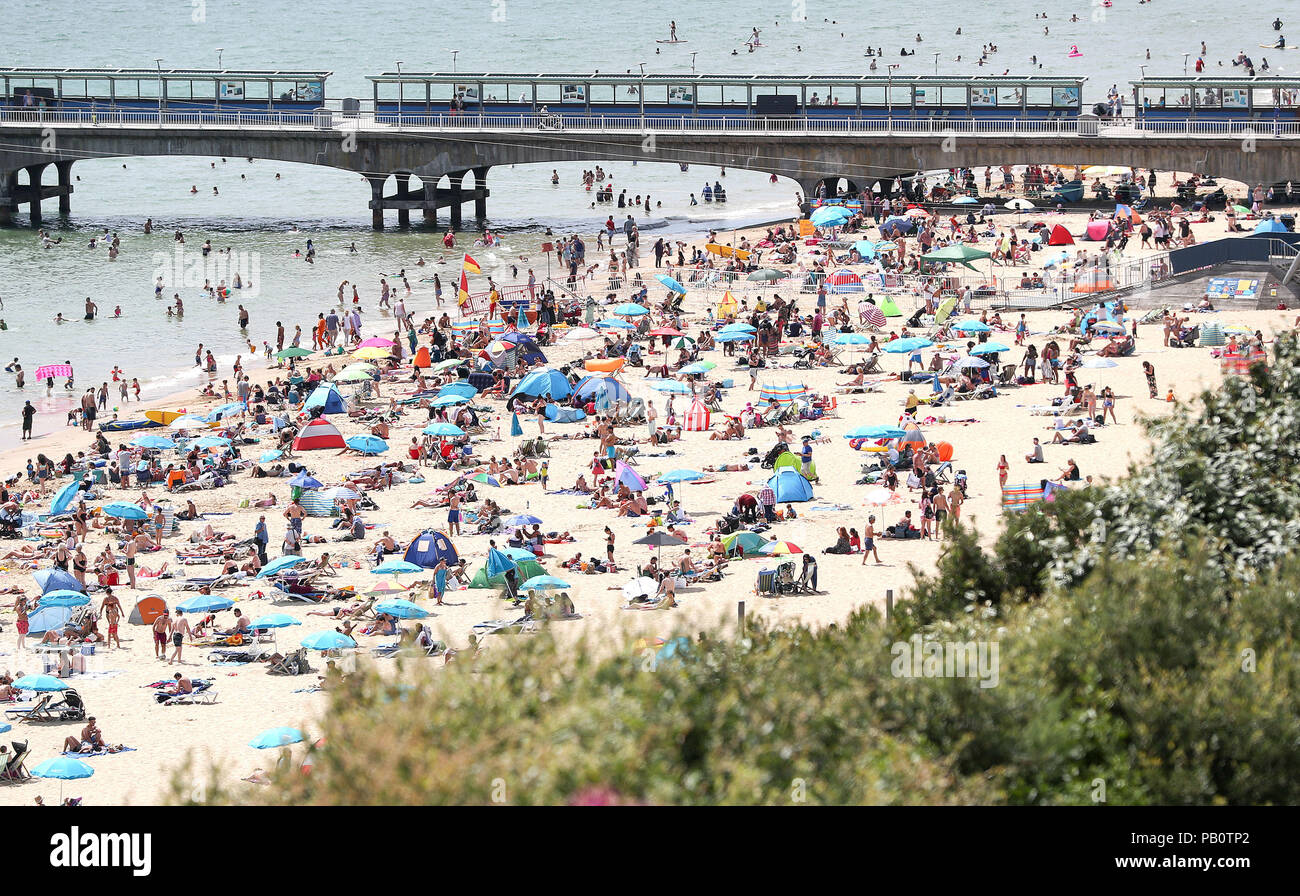 People enjoying the heatwave today on Bournemouth beach in Dorset as the hot weather continues across the UK, marking the driest start to a summer since modern records began in 1961. Stock Photo