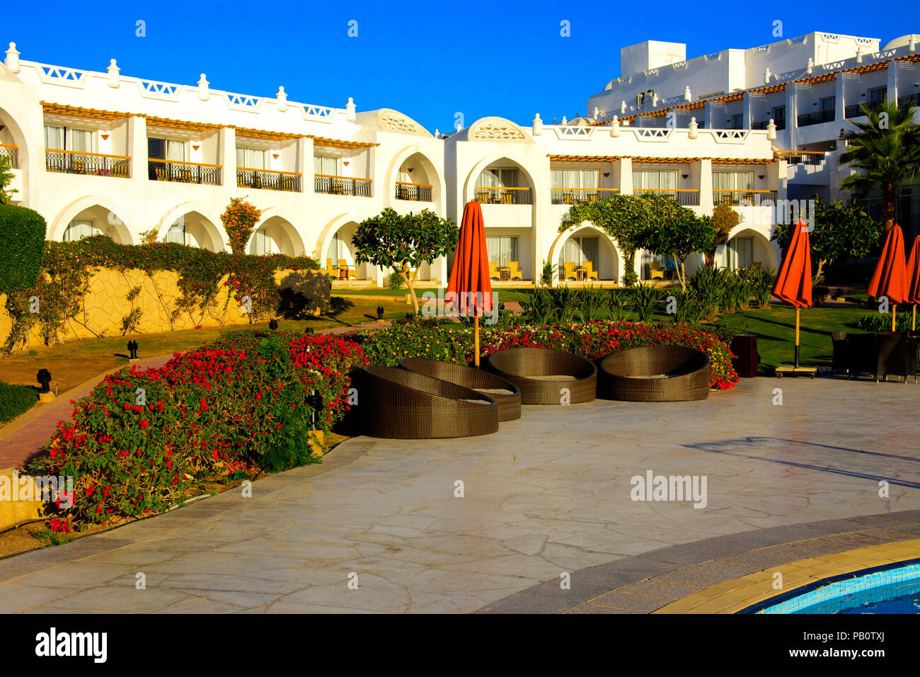 Sharm el-Sheikh, Egypt - March 14, 2018. The courtyards of a magnificent white hotel on a summer day. The concept of tourism, vacations and luxury rec Stock Photo