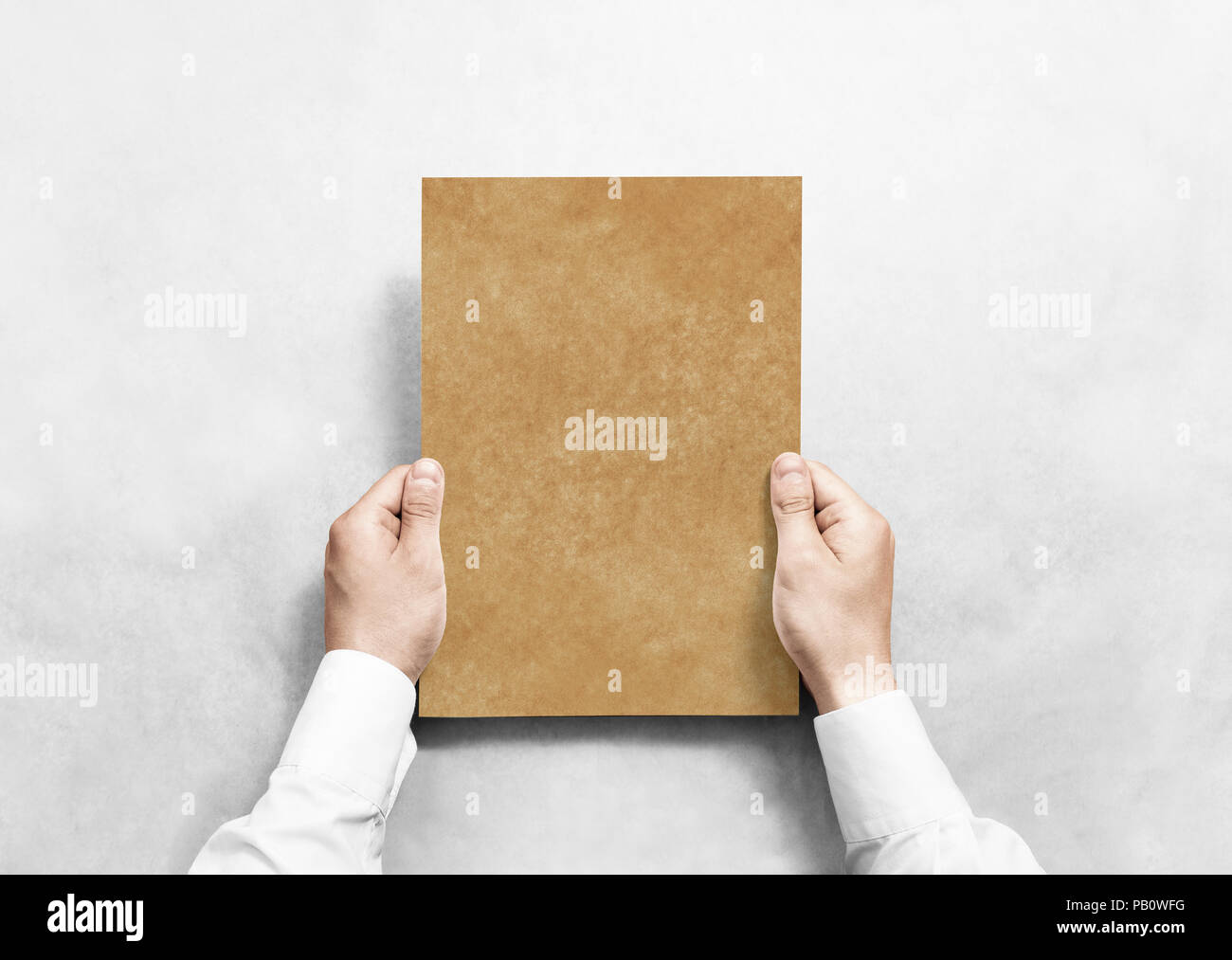 Hand holding kraft blank paper sheet mockup, isolated. Arm in shirt hold craft  brochure template mock up. Leaflet document surface design. Simple brow  Stock Photo - Alamy