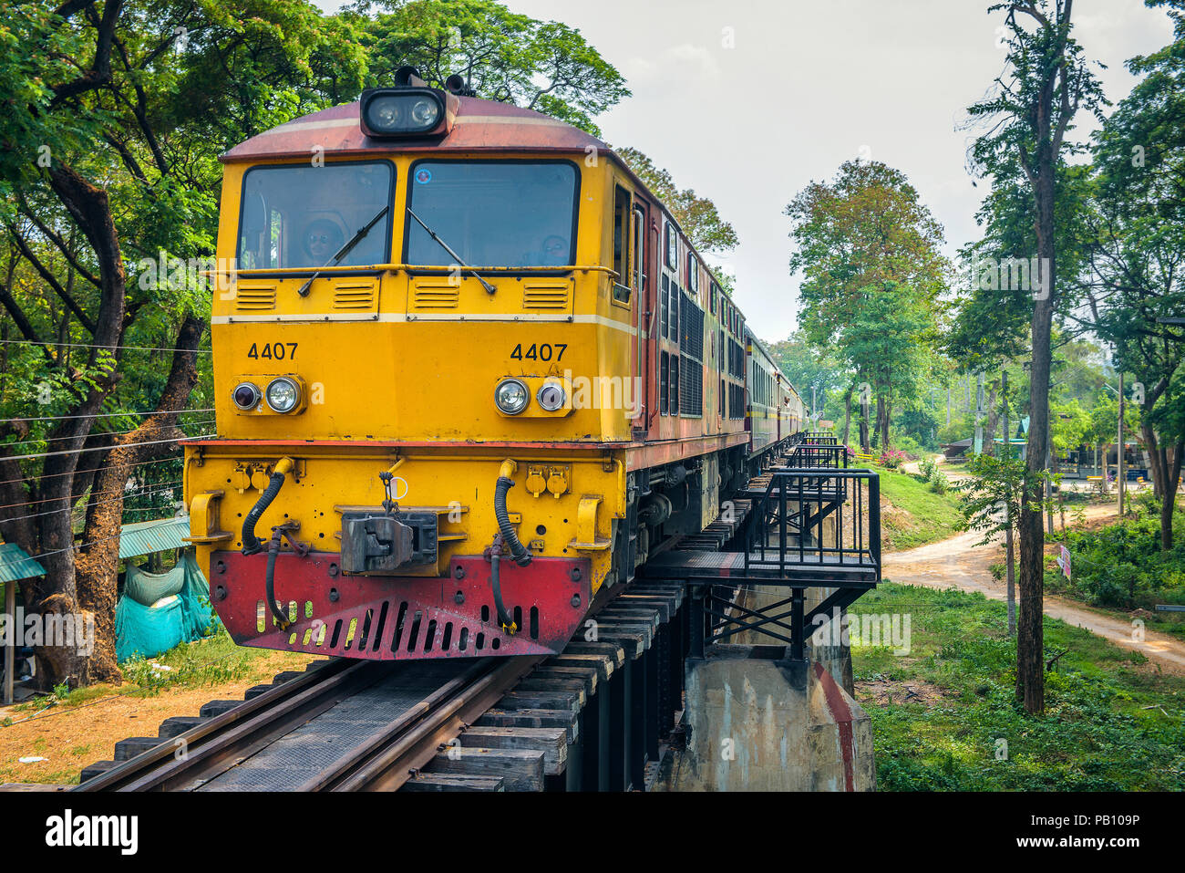 Thai train on the historical bridge over the river Kwai Stock Photo