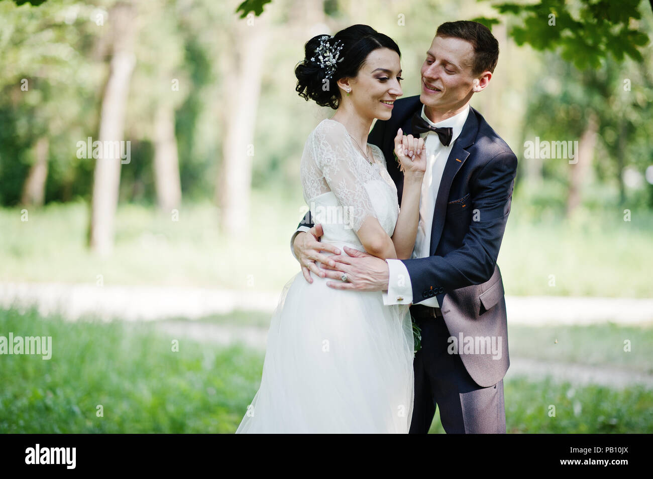Beautiful wedding couple dancing outdoors in the park Stock Photo - Alamy