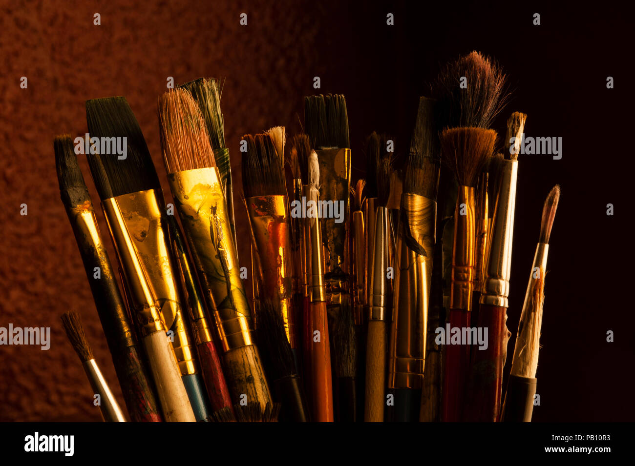 Paint brushes, still life with warm light. Stock Photo
