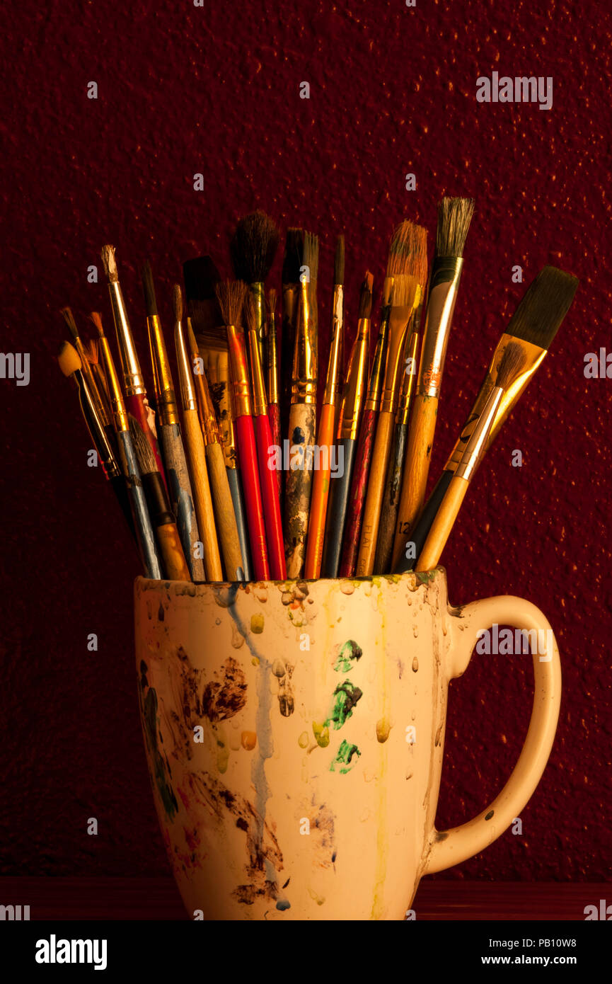 Paint brushes with gouache in cup isolated on white Stock Photo