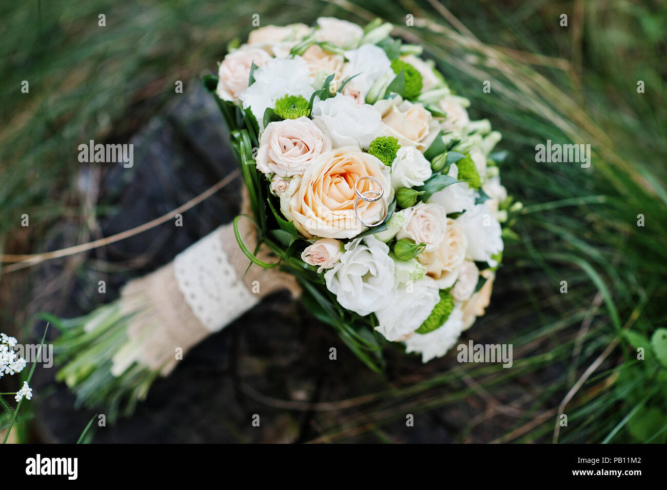 Close-up photo of wedding bouquet made of roses on the stump. Stock Photo