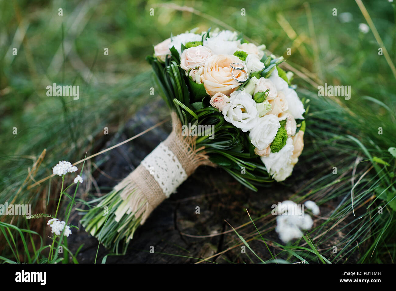 Close-up photo of wedding bouquet made of roses on the stump. Stock Photo