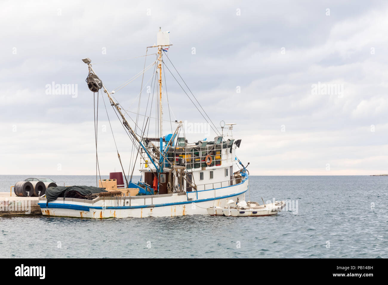 Fishing boat mooring at the pier in mediterranean sea Stock Photo - Alamy