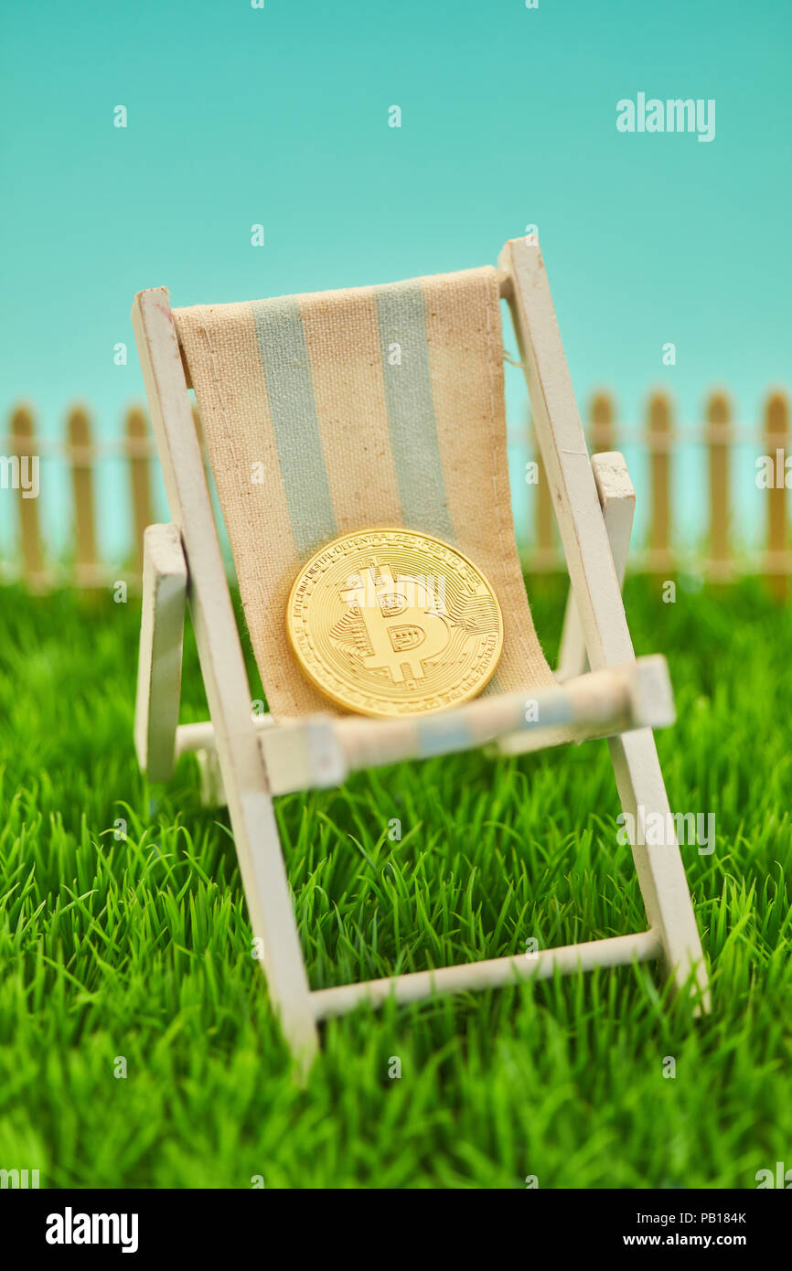Golden Bitcoin coin lies in deckchair as a retirement concept Stock Photo -  Alamy