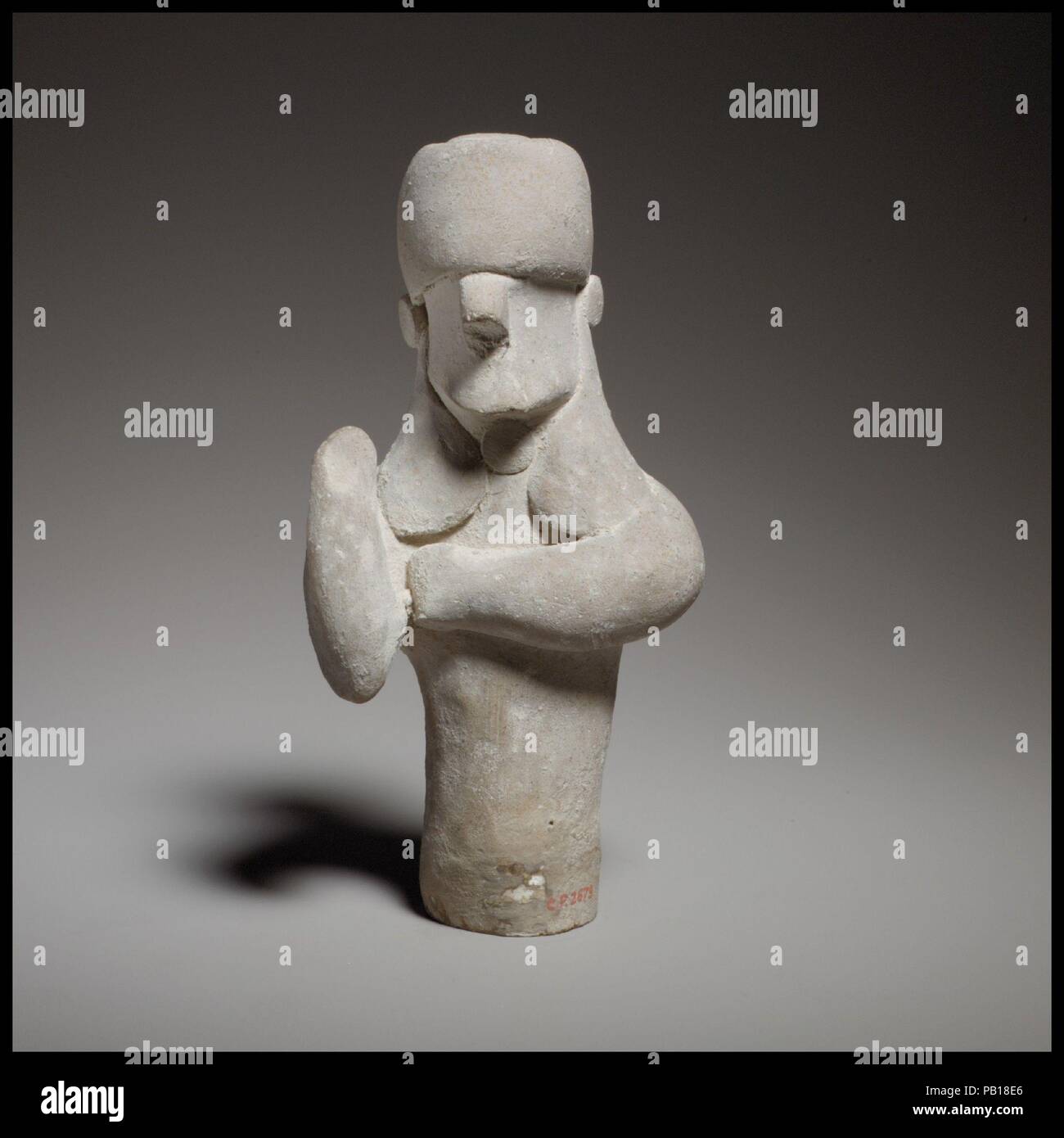 Standing male figurine. Culture: Cypriot. Dimensions: H. 6 1/16 in. (15.4 cm). Date: ca. 600-480 B.C..  The cylindrical body, the lower part of which is missing, is handmade and solid. Museum: Metropolitan Museum of Art, New York, USA. Stock Photo