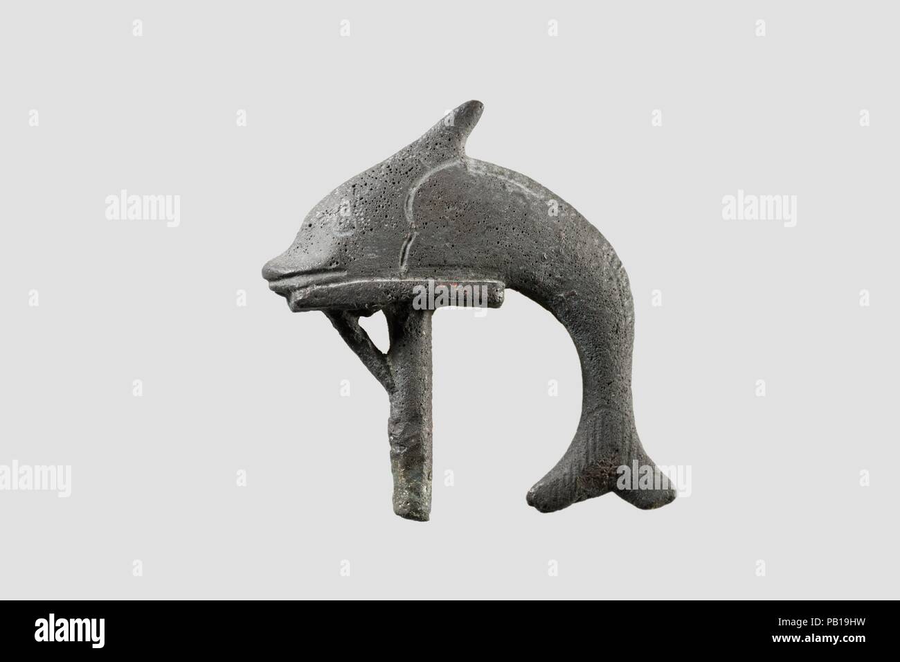 Schilbe fish, sacred to Hatmehyt, on standard. Dimensions: h. 5.7 cm (2 1/4) × l. 5.7 cm (2 1/4 in.). Date: 664-30 B.C..  The schlibe fish was illustrated atop the standard of the nome of Mendes in the eastern Delta since earliest times. It was very closely associated with the local goddess Hatmehyt , whose name in fact means 'Foremost of the Fishes' and who wore the schilbe atop her crown and hanging down her back (89.2.517).   Hatmehyt was the only Egyptian god(dess) associated so closely with a fish, and this certainly has to do with the importance of the swampy damp environment of the area Stock Photo