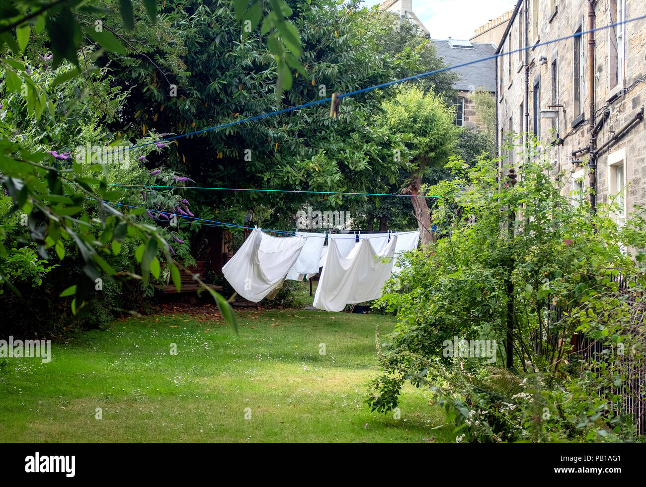 Washing hanging out to dry in tenement garden, Stockbridge, Edinburgh, Scotland, United Kingdom. Stock Photo