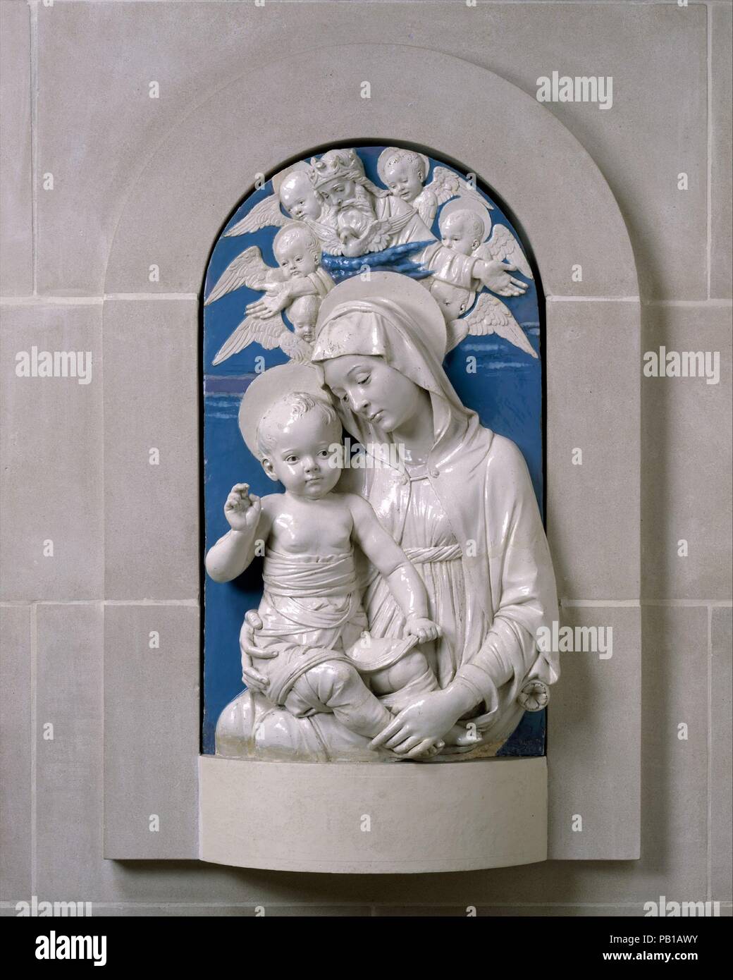 Virgin and Child. Artist: Andrea della Robbia (Italian, 1435-1525). Culture: Italian, Florence. Dimensions: 37 3/8 x 21 5/8 in.  (94.9 x 54.9 cm). Date: ca. 1470-75.  Andrea was the nephew and disciple of Luca della Robbia, who developed the blue and white glazes used on terracotta sculpture with which the name della Robbia is associated. By the time he made the Lehman Madonna, about 1470-75, Andrea had for some years been chiefly responsible for the output of the family shop in the via Guelfa, Florence.  Although he was a faithful follower of his uncle's style, his own personality emerged in  Stock Photo