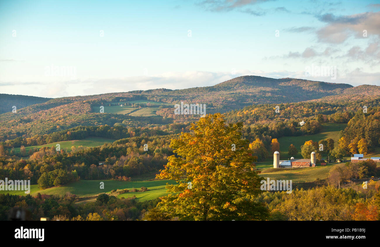 A peaceful family farm amidst the colorful autumn foliage in Vermont green mountains Stock Photo