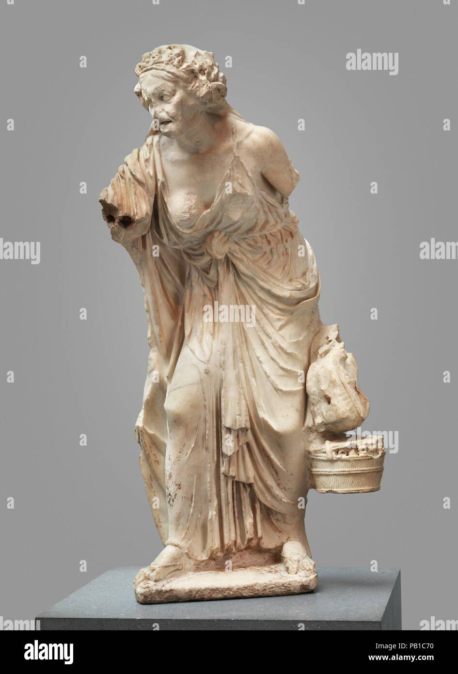 Marble statue of an old woman. Culture: Roman. Dimensions: H. 49 5/8 in. (125.98 cm). Date: A.D. 14-68.  Copy of a Greek work of the second century B.C.  During the Hellenistic period, artists became concerned with the accurate representation of childhood, old age, and even physical deformity. The range of subject matter was extended to include genre-like figures from the fringes of society. Fine, large-scale statues of fishermen, peasants, and aged courtesans became valued religious dedications, sometimes placed in a park-like setting within the  sanctuary of the god. Although this statue is  Stock Photo