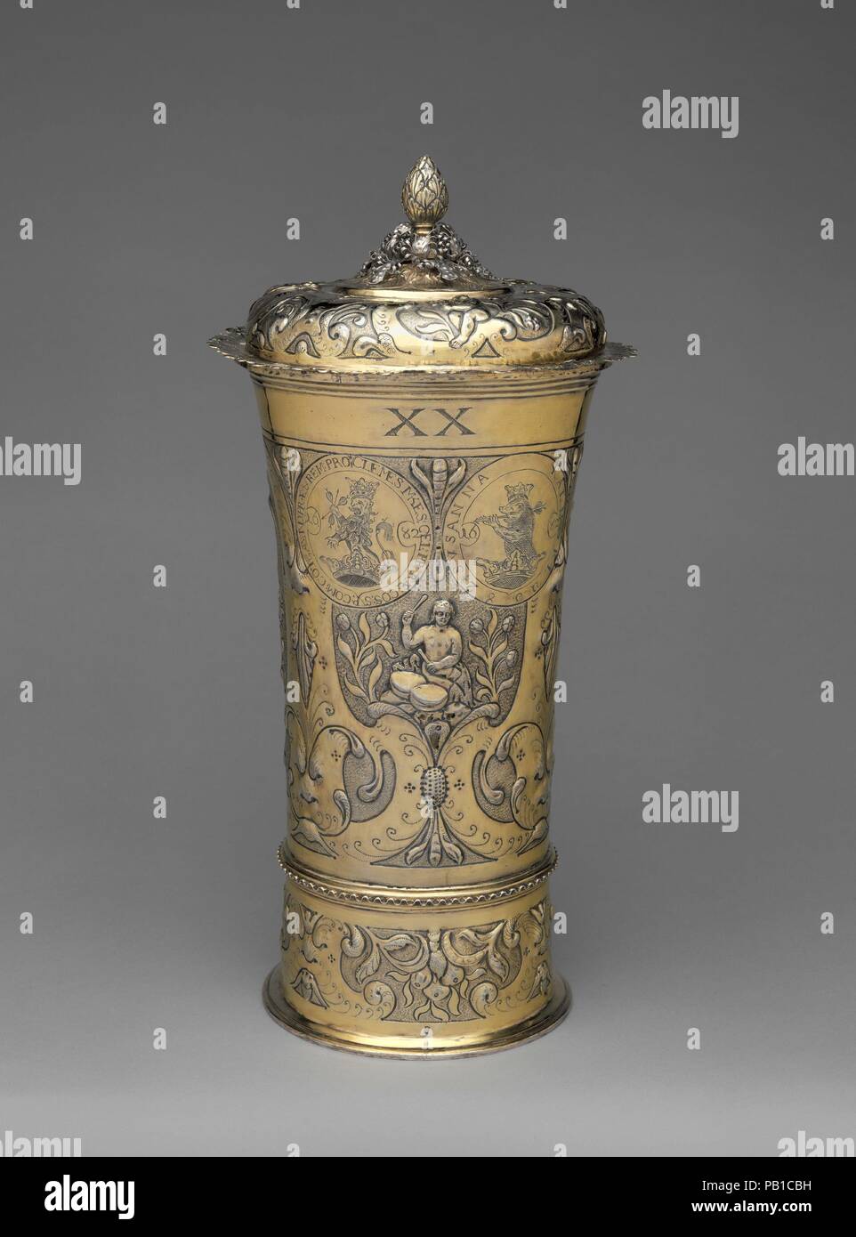 Footed beaker with cover. Culture: Hungarian, Brassó. Dimensions: Overall: 15 3/4 x 6 11/16 in. (40 x 17 cm). Maker: Johannes (Hans) Mautner (master 1670, died 1694). Date: 1682.  This monumental beaker is the one of the largest known of its type. It has a hollow base and an undulating ring that marks the actual bottom of the vessel on the outside. Both of these features are characteristic of Hungarian and Transylvanian production. The inscribed coat of arms at left indicates that it belonged to a member of a princely Transylvanian family, Count Mikes, who came from one of the most ancient dyn Stock Photo