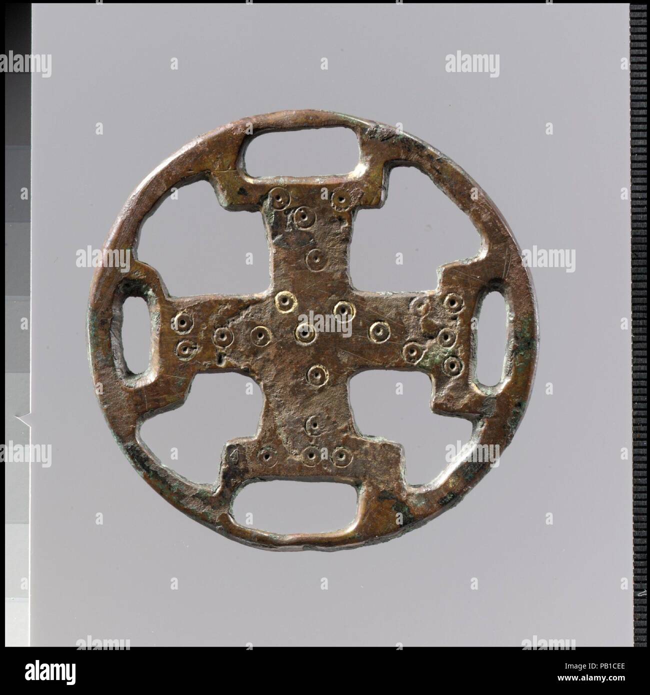 Openwork Belt Fitting. Culture: Frankish. Dimensions: Overall: 2 5/16 x 1/8 in. (5.9 x 0.3 cm). Date: 600-700.  Openwork plaques were hung from a belt by a strap. Such useful objects as combs, keys, or amulets would then be suspended from the plaque by chains or strings. The patterns on these belt fittings ranged from architectural motifs to human figures to abstract designs. Museum: Metropolitan Museum of Art, New York, USA. Stock Photo