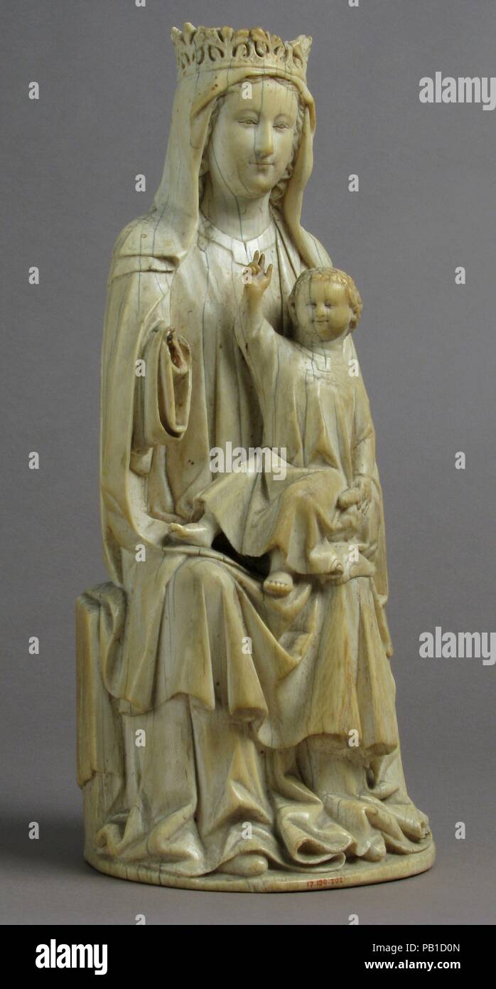 Virgin and Child. Culture: French. Dimensions: Overall: 10 15/16 x 4 5/8 x 4 in. (27.8 x 11.8 x 10.2 cm). Date: 14th century.  Used for daily devotions to the Virgin and Child such figures may have been placed on an altar within a tabernacle. The apparent wear on the carving may have been caused by repeated touching and kissing. It may come from a Franciscan community, the Minori Osservanti in Foglino or perhaps Assisi. Museum: Metropolitan Museum of Art, New York, USA. Stock Photo