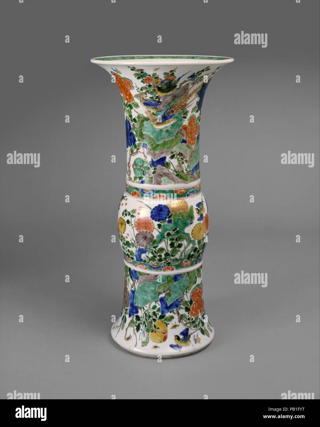 Vase in Shape of Archaic Bronze Vessel with Flowers and Birds. Culture: China. Dimensions: H. 18 in. (45.7 cm). Date: late 17th-early 18th century.  The shape of this vase ultimately derives from archaic vessels used to serve and store wines. The decoration of flowers and birds is ubiquitous in Chinese art; however, the palette used to decorate the piece evolved in the seventeenth century as a refinement of earlier traditions. Museum: Metropolitan Museum of Art, New York, USA. Stock Photo