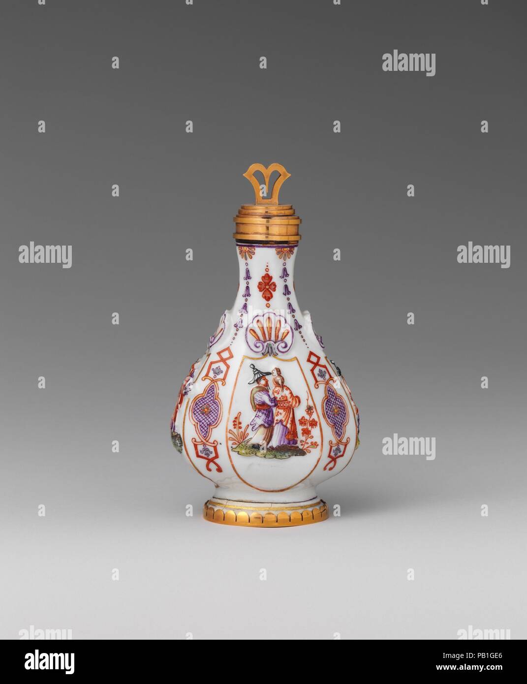 Scent bottle. Culture: Austrian, Vienna. Dimensions: Height: 3 3/8 in. (8.6 cm). Factory: Vienna. Factory director: Du Paquier period (1718-1744). Date: ca. 1730.  Medieval travelers used leather pilgrim flasks to transport water. The form was appropriated in later centuries for large, opulent examples made in silver or glass. Employed on small scale, it was an appropriate choice for a luxury object intended to hold an expensive fragrance. This example is embellished with low-relief decoration, including shells and chinoiserie figures, and ornamental strapwork. Museum: Metropolitan Museum of A Stock Photo
