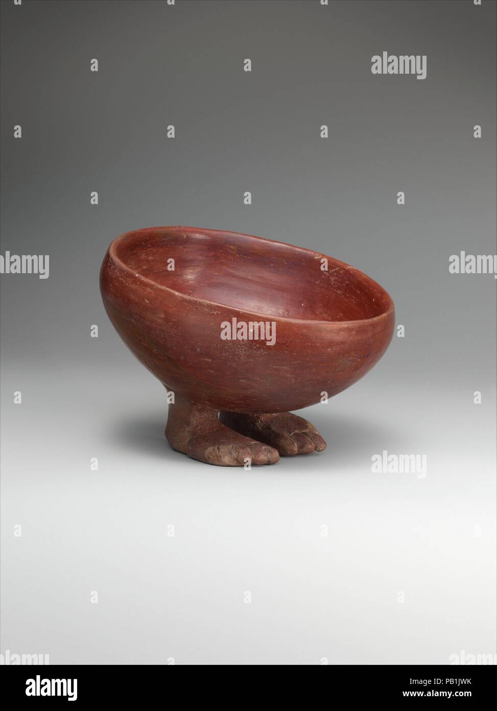 Bowl with Human Feet. Dimensions: diam. 13.2 x W. 13.7 x D. 9.8 cm (5 3/16 x 5 3/8 x 3 7/8 in.). Date: ca. 3900-3650 B.C..  In the Predynastic Period, potters created a wide variety of ceramic vessels. One unusual type is a bowl with supports shaped like human feet. This simple, round bowl, tipped slightly forward as if to offer its contents, has two such feet solidly attached to its underside. Made from Nile clay, the bowl has a smoothed, slipped, and polished surface, giving it a light sheen. The bowl standing on feet is very similar in form to the Egyptian hieroglyph meaning 'to bring.' Sin Stock Photo