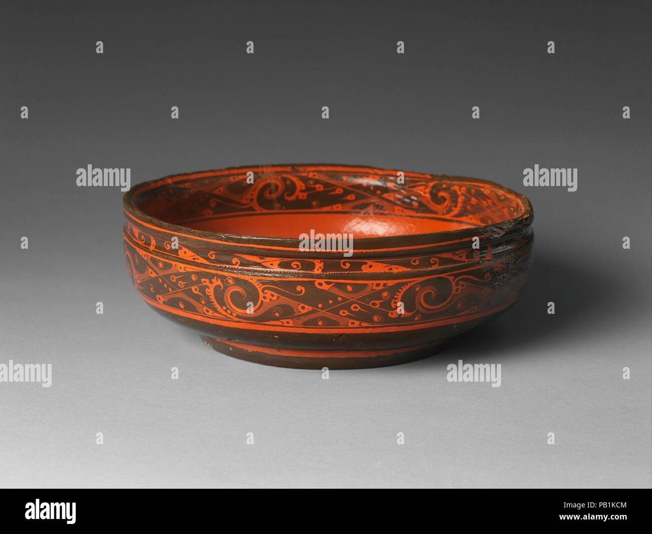 Bowl with Geometric Designs. Culture: China. Dimensions: H. 3 5/8 in. (9.2 cm); Diam. 10 7/16 in. (26.5 cm). Date: 2nd century B.C..  Likely used for serving a liquid such as wine or soup, this bowl is painted with dramatic swirling lines interlaced with small curls and other forms. Known as cloud energy, or yunqi,  this design, which was pervasive during the Western Han dynasty, is understood to represent a forbidding but numinous realm inhabited by immortals. Museum: Metropolitan Museum of Art, New York, USA. Stock Photo