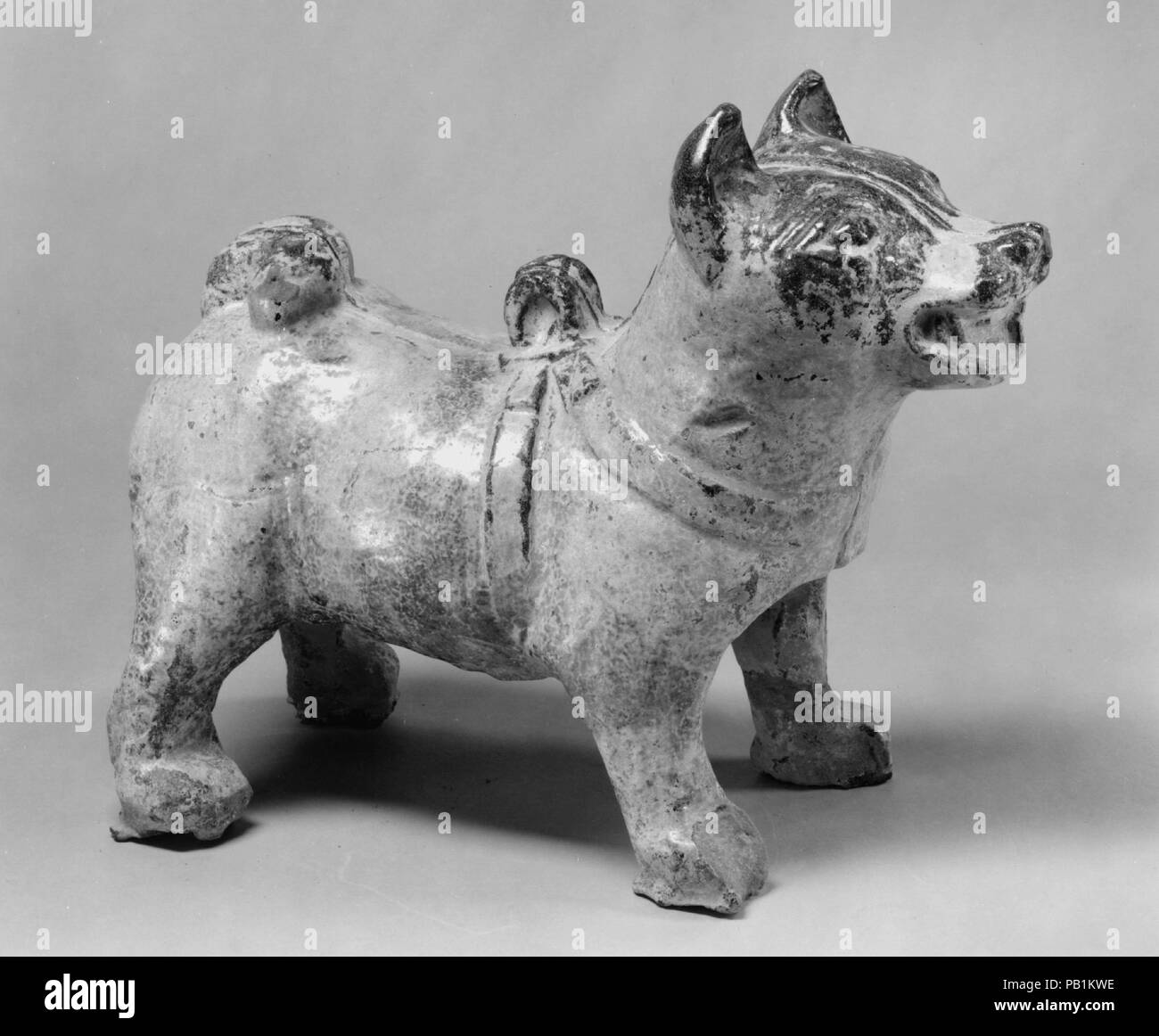 Figure of a Standing Dog. Culture: China. Dimensions: H. 8 7/16 in. (21.4 cm); W. 5 5/8 in. (14.3 cm); L. 11 in. (27.9 cm). Date: 1st-2nd century. Museum: Metropolitan Museum of Art, New York, USA. Stock Photo