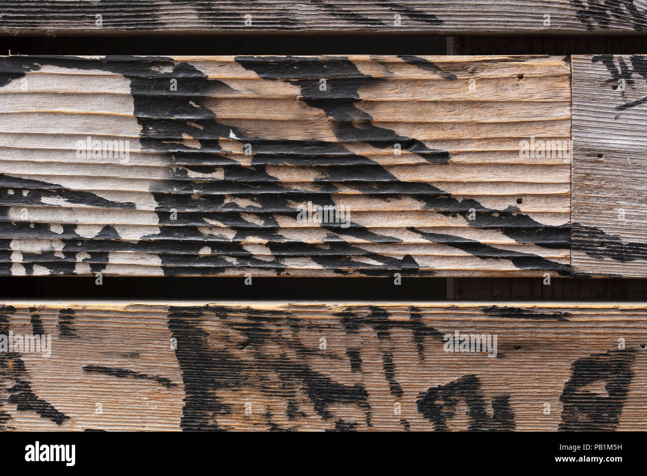 Wood fence slats with burned markings Stock Photo