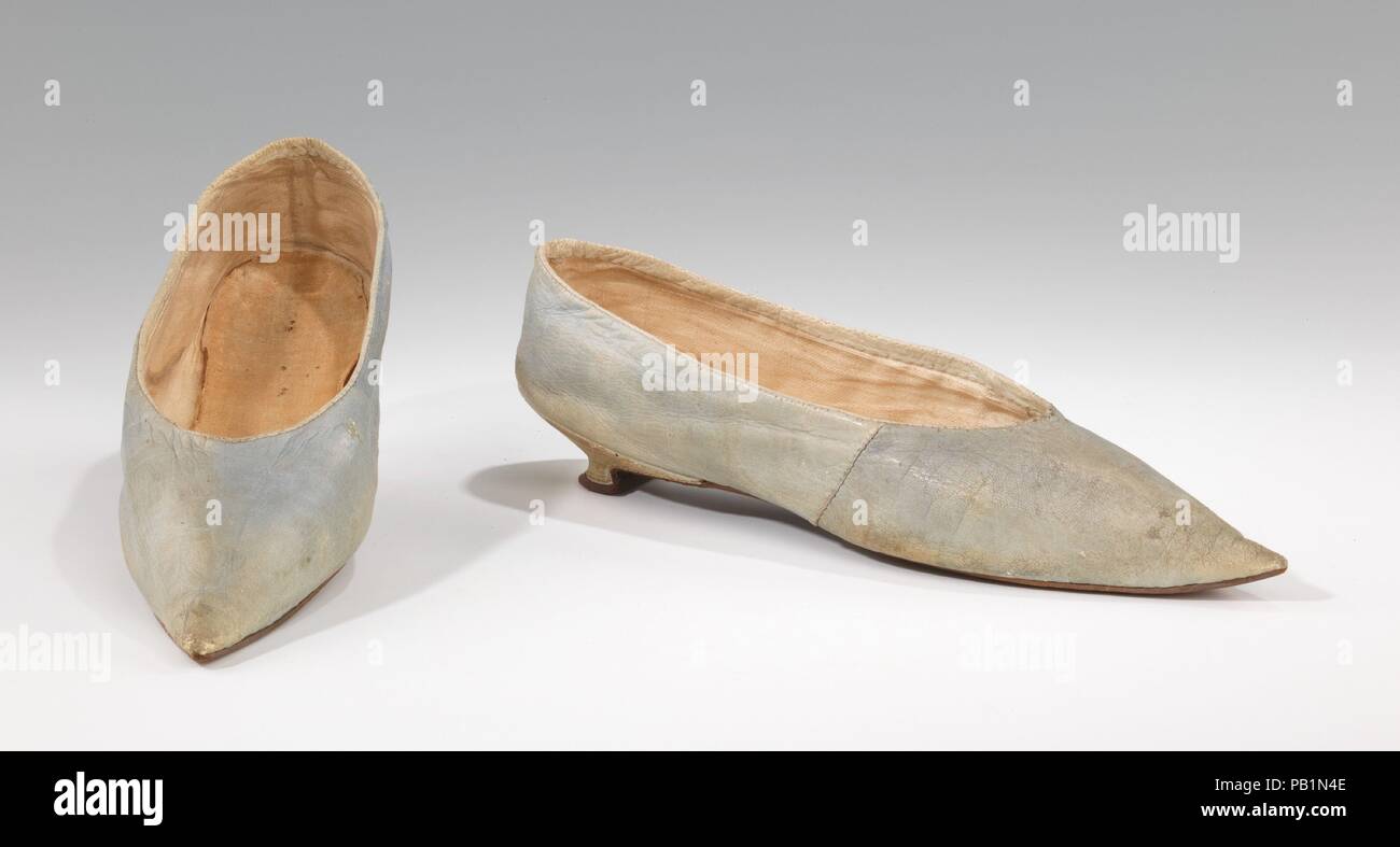 Slippers. Culture: probably British. Date: 1795-1810. The transition from  the high-heeled shoes of 18th century to flat 19th century styles is  exemplified by this pair of delicately colored slippers. The sharply pointed