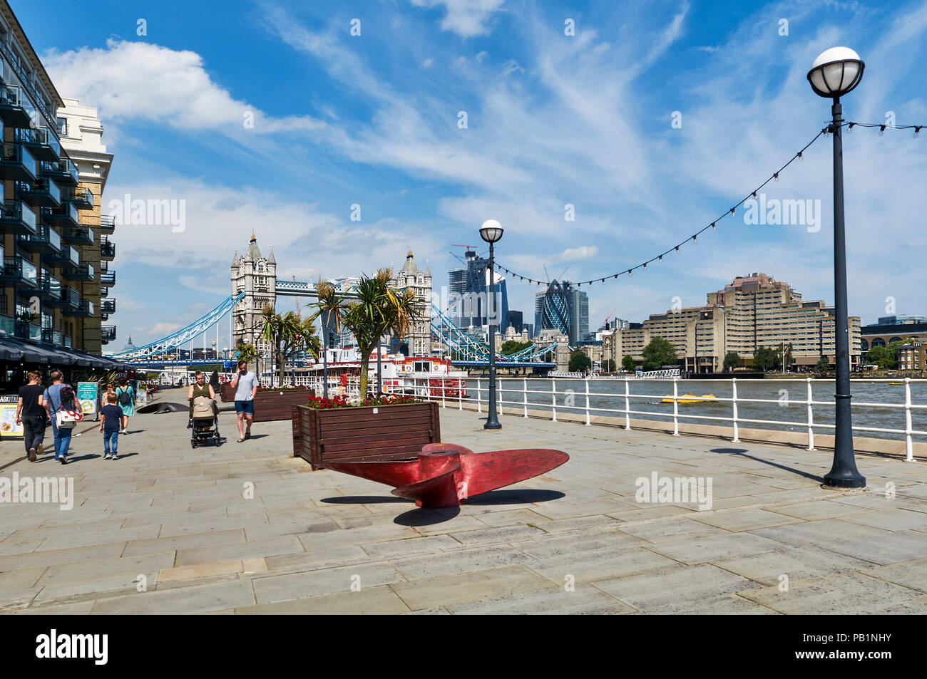 Pedestrianised area by the River Thames, behind Butler's Wharf on the South Bank, looking west towards Tower Bridge, London UK Stock Photo