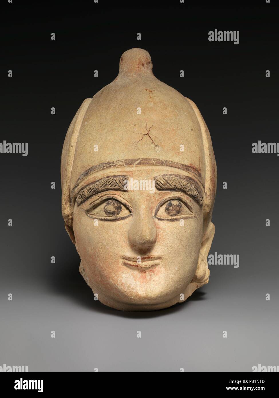 Terracotta head of a man. Culture: Cypriot. Dimensions: H. 8 3/4 in. (22.2 cm). Date: ca. 600 B.C..  The manufacture of large scale hollow terracotta sculpture on Cyprus began in the mid-seventh century B.C.  This is one of the finest examples of the 'Neo-Cypriot' style, characterized by fine features, large ridged eyes, feathered eyebrows, and a lot of color. Museum: Metropolitan Museum of Art, New York, USA. Stock Photo