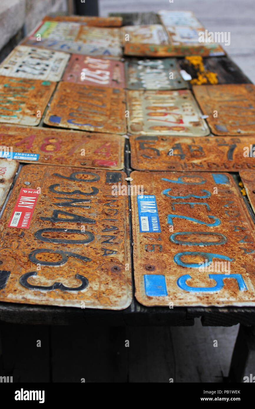 Rusted and old vintage license plate work table in the back Alley of Bookman's Alley bookstore in Evanston, Illinois. Stock Photo