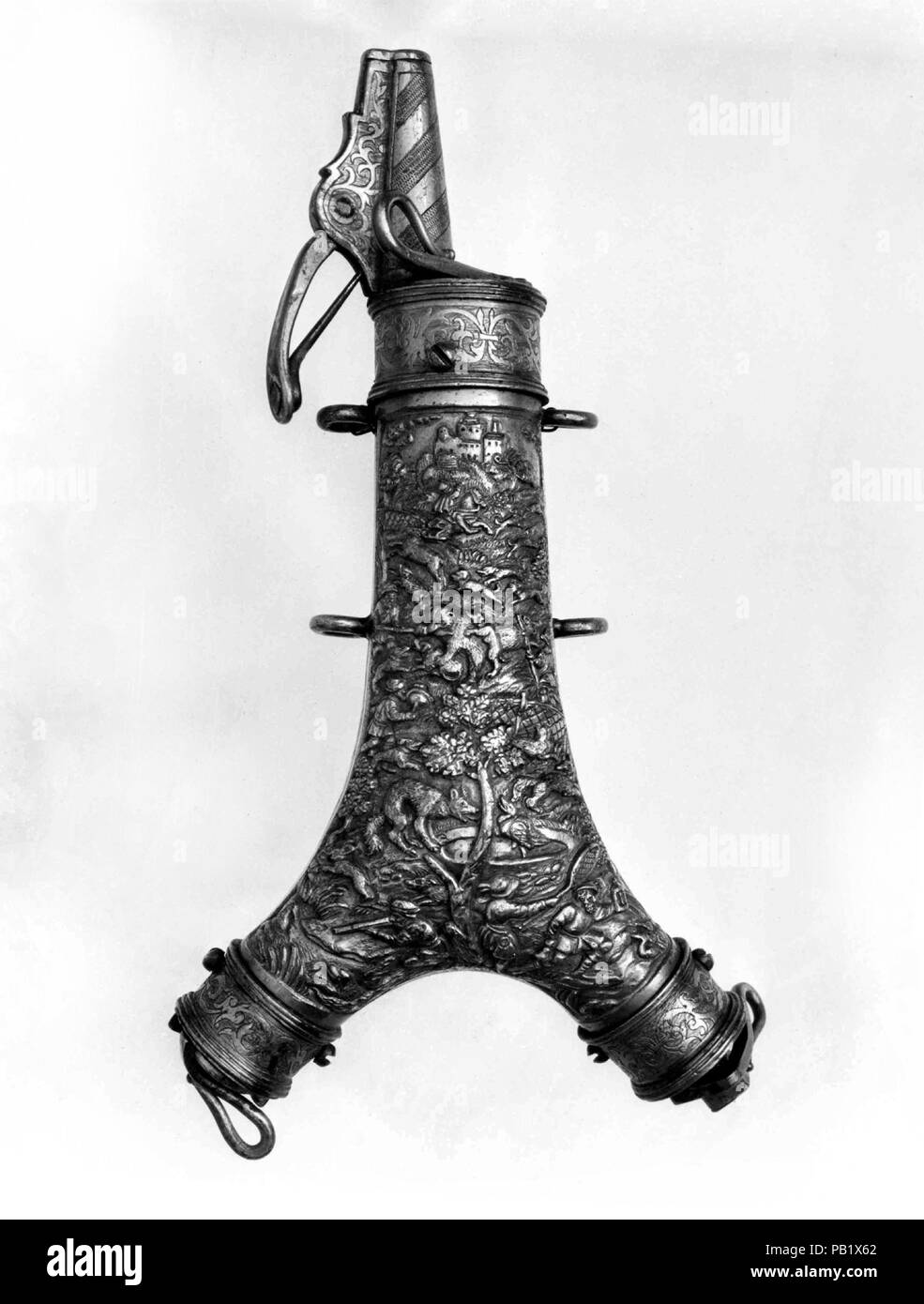 Powder Flask with Spanner, Primer, and Bullet Compartment. Culture: German, Augsburg or Nuremberg. Dimensions: L. 9 1/8 in. (23.2 cm); W. 4 3/4 in. (12.1 cm); Wt. 1 lb. 1 oz. (481.9 g). Date: late 16th century.  The relief decoration on the front includes hunting scenes. The engraving on the back shows the coat of arms of the Bavarian nobleman Hans Albrecht von Closen. Museum: Metropolitan Museum of Art, New York, USA. Stock Photo