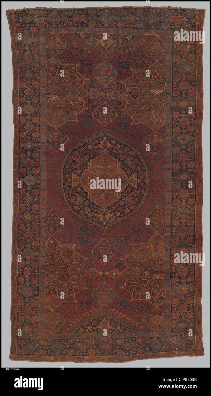 'Medallion Ushak' Carpet. Dimensions: Rug: H. 234 1/2 in. (595.6 cm)  W. 132 in. (335.3 cm). Date: 17th century.  Made in large numbers and hugely popular both in the Ottoman empire and in Europe, medallion Ushak carpets such as this were produced from the later fifteenth century to the eighteenth. The design in theory repeats infinitely in all directions, although 'cut' by the border. It consists of ogival medallions alternating with smaller eight-lobed 'stars.'. Museum: Metropolitan Museum of Art, New York, USA. Stock Photo