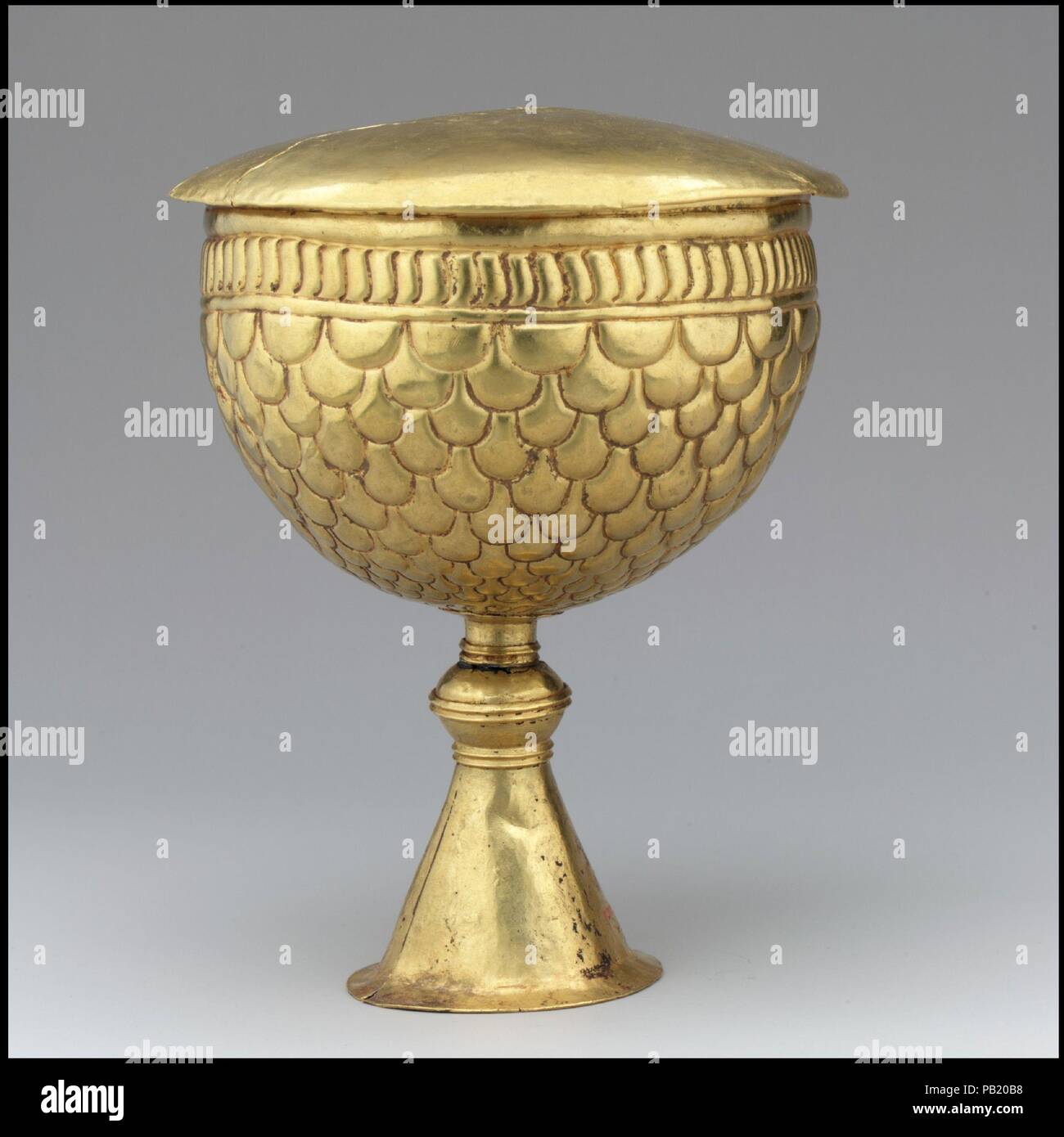 Gold Goblet and Cover (?). Culture: Avar or Byzantine. Dimensions: a only: 6 5/8 × 4 3/4 in., 13.439 Troy Ounces (16.8 × 12.1 cm, 418g)  b only: 1.993 Troy Ounces (62g). Date: 700s.  This goblet may in fact be a Byzantine export, though the foot of the cup does not conform to the standard shape of Byzantine chalices.  The Avars  The Avars were a nomadic tribe of mounted warriors from the Eurasian steppe. The Byzantine emperor Justinian negotiated with them in the sixth century to protect the Empire's northern border along the Black Sea. Emboldened by their subjugation of numerous tribes, they  Stock Photo